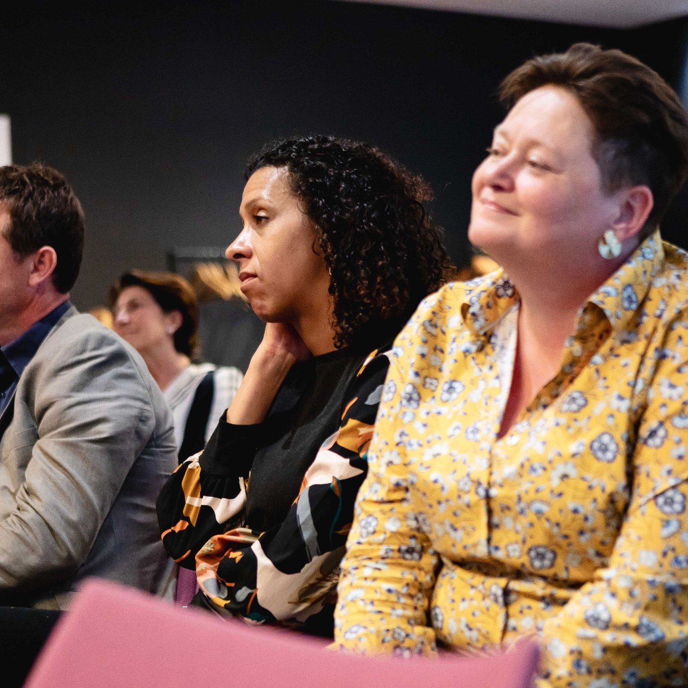Audience listening closely during a session